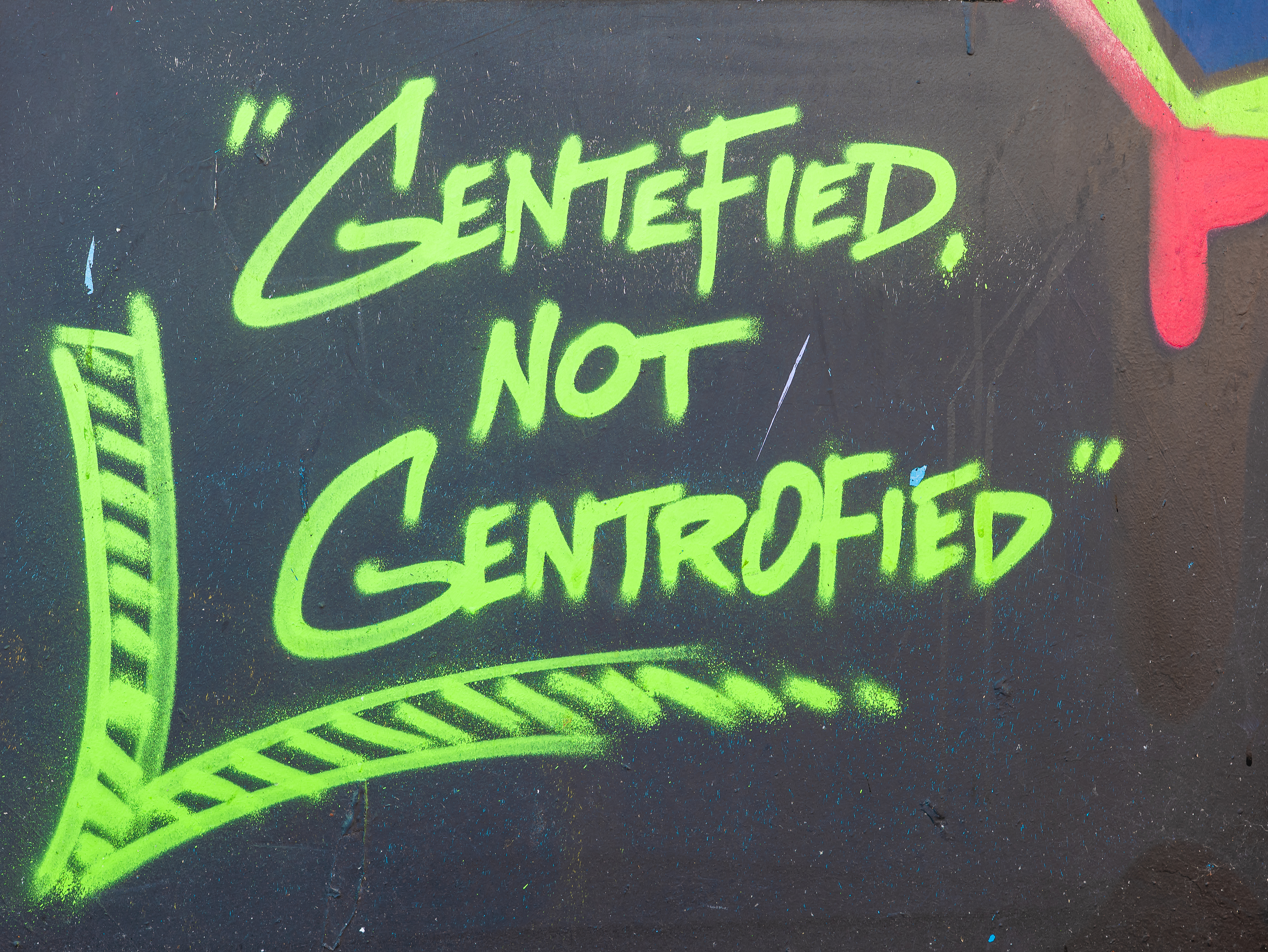 “A better day” -- sprayed in neon green against the dark.